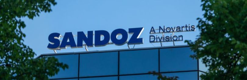 Sandoz company logo on office building in Warsaw city centre [Credit: Konektus Photo/Shutterstock.com].