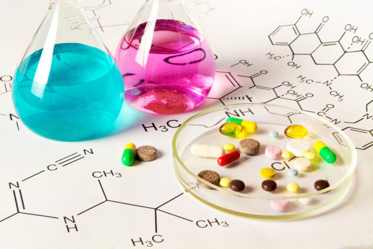 Chemicals in vials next to range of pills